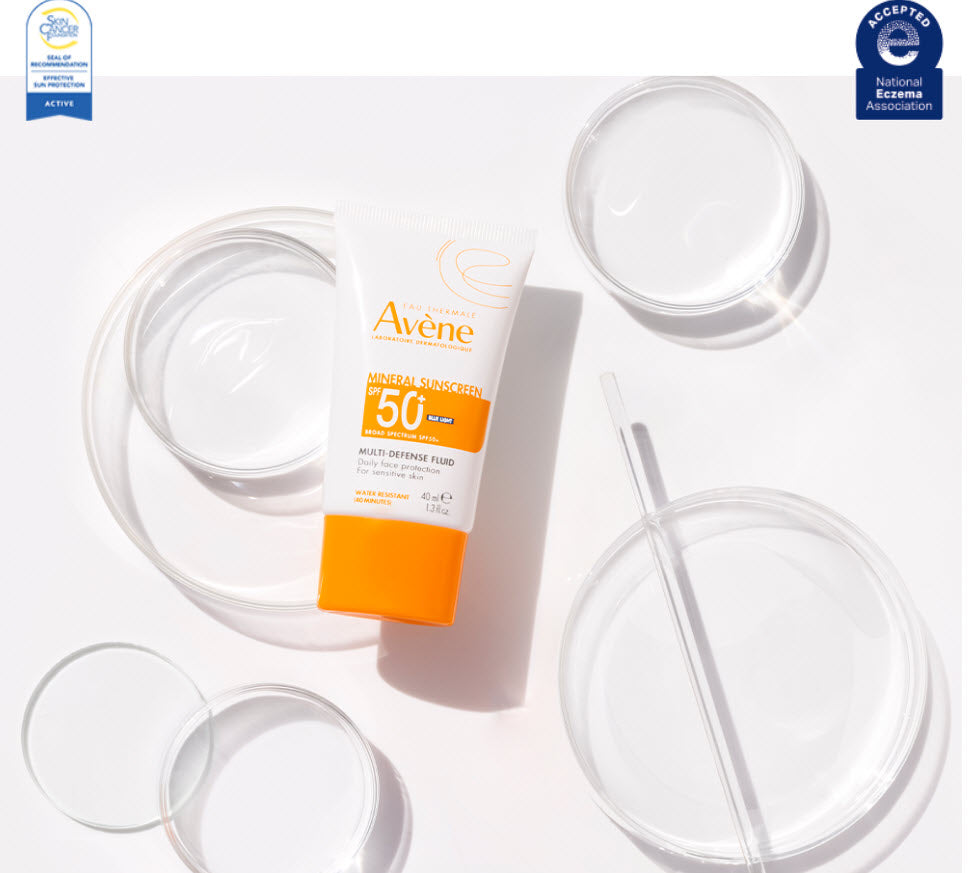 Avene Mineral Sunscreen Multi-Defense Fluid SPF 50+ tube styled with glass dishes