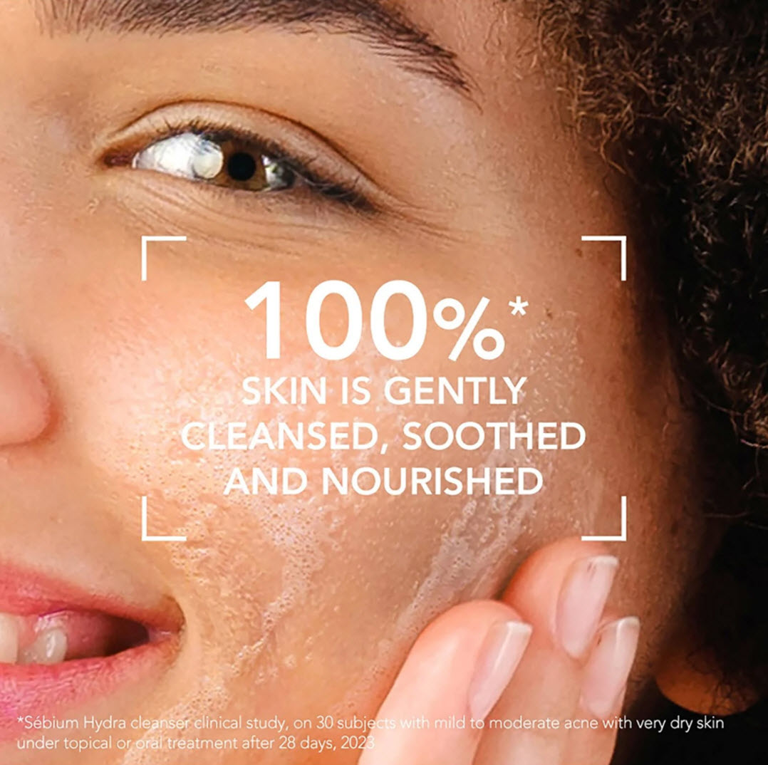 Woman massaging Bioderma Sebium Hydra Cleanser into her cheek, with clinical study result showing 100% of skin was gently cleansed, soothed and nourished