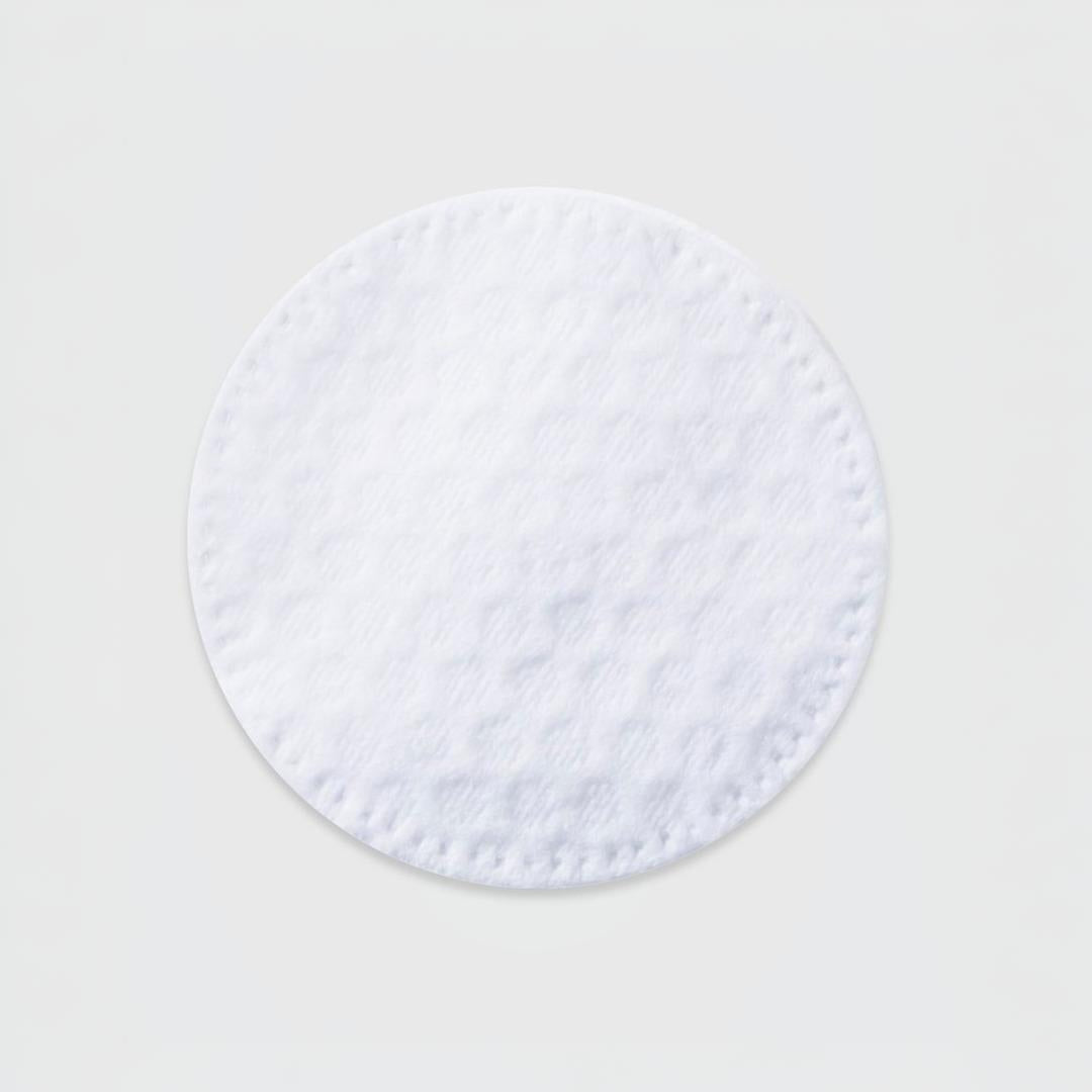 Clinical Skin A.C.E. Treatment Pad close-up – single round white exfoliating and illuminating pre-soaked treatment pad with textured surface and stitched edge on gray background