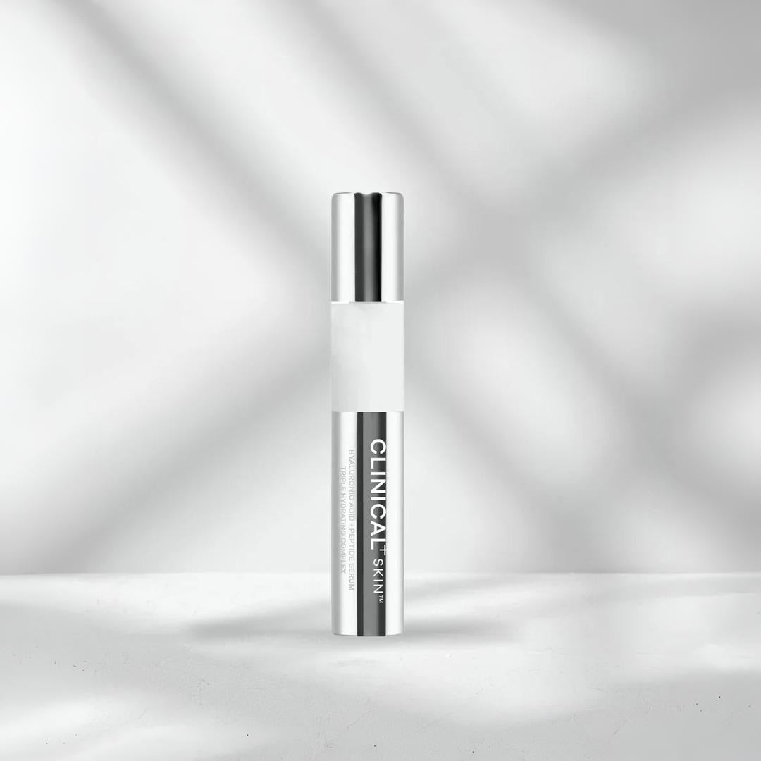 Clinical Skin Hyaluronic Acid + Peptide Serum 1 fl oz – triple hydrating complex serum in slim chrome pump tube on gray background to deeply hydrate, plump and smooth skin with hyaluronic acid and peptides