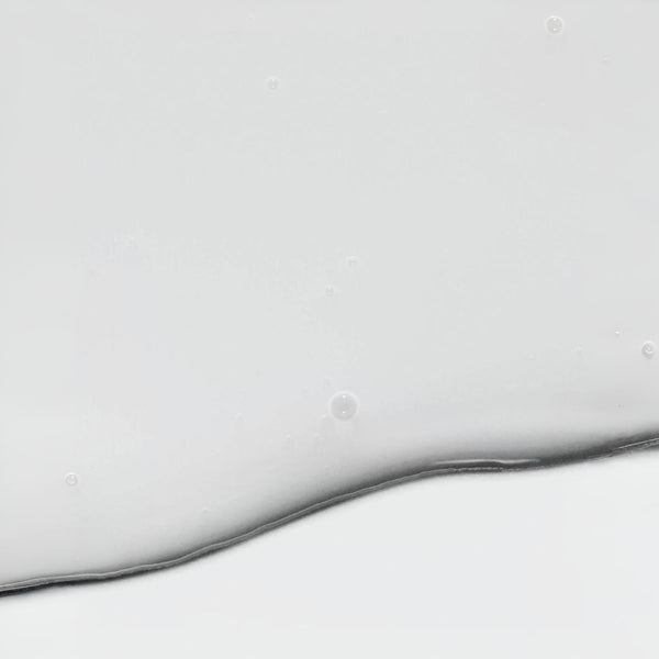 Clinical Skin Polypeptide Firming Serum texture close-up – smooth milky lightweight serum formula with air bubbles on gray background showing the firming polypeptide serum texture