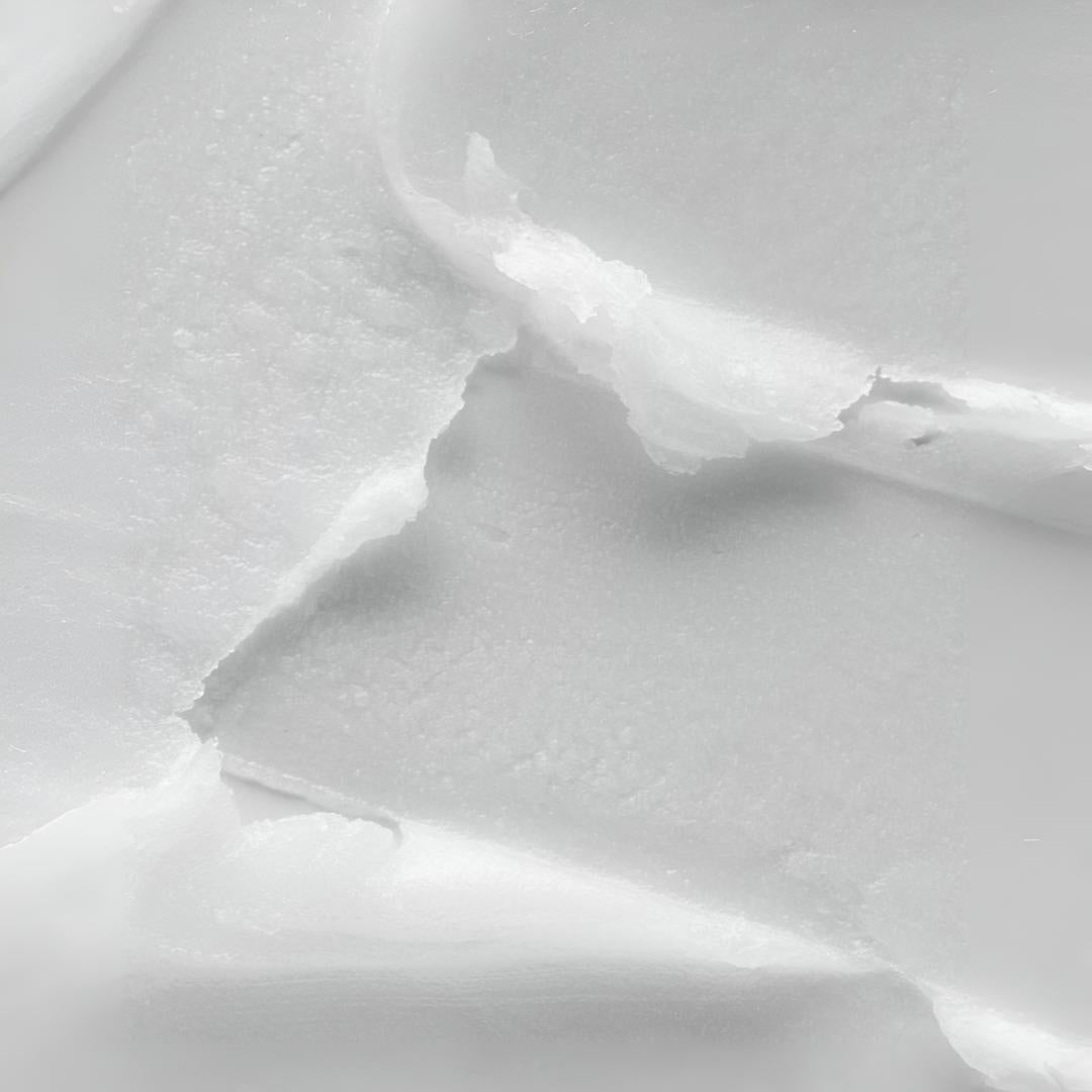 Clinical Skin Rejuvenating Corrective Eye Balm texture close-up – thick dense white balm with firm waxy texture showing the ultra-firming formula for intensive rejuvenation of the eye area