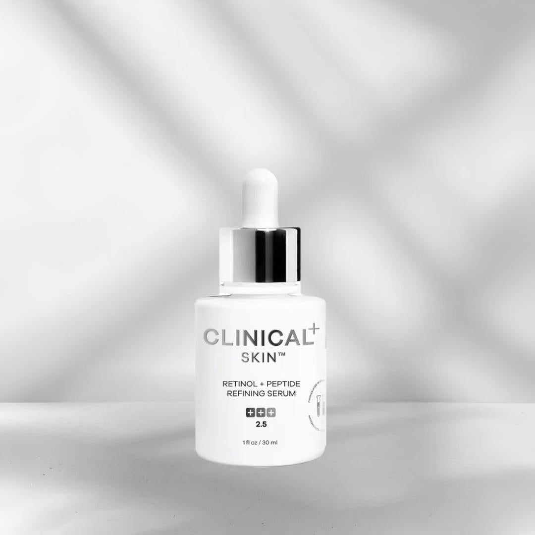 Clinical Skin Retinol + Peptide Refining Serum 1 oz – strength 2.5 retinol and peptide serum in white dropper bottle on gray background with soft light shadows for skin refining and anti-aging