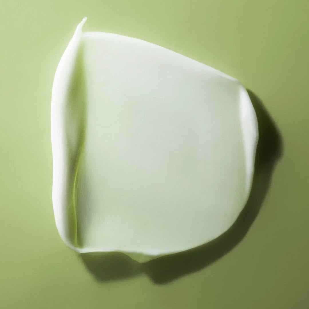 Creamy texture swatch of Cool As A Cucumber Barriersmith Lipid Treatment Cream on a green background