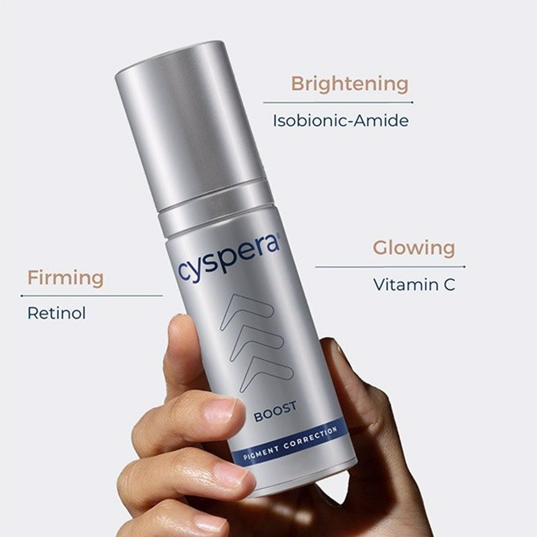 Cyspera Boost bottle held in hand showing key ingredients brightening isobionic-amide glowing vitamin C and firming retinol