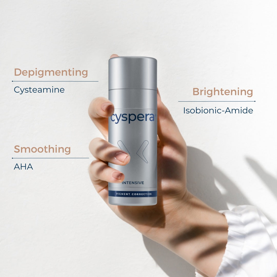 Cyspera Intensive bottle held in hand showing key ingredients depigmenting cysteamine brightening isobionic-amide and smoothing AHA