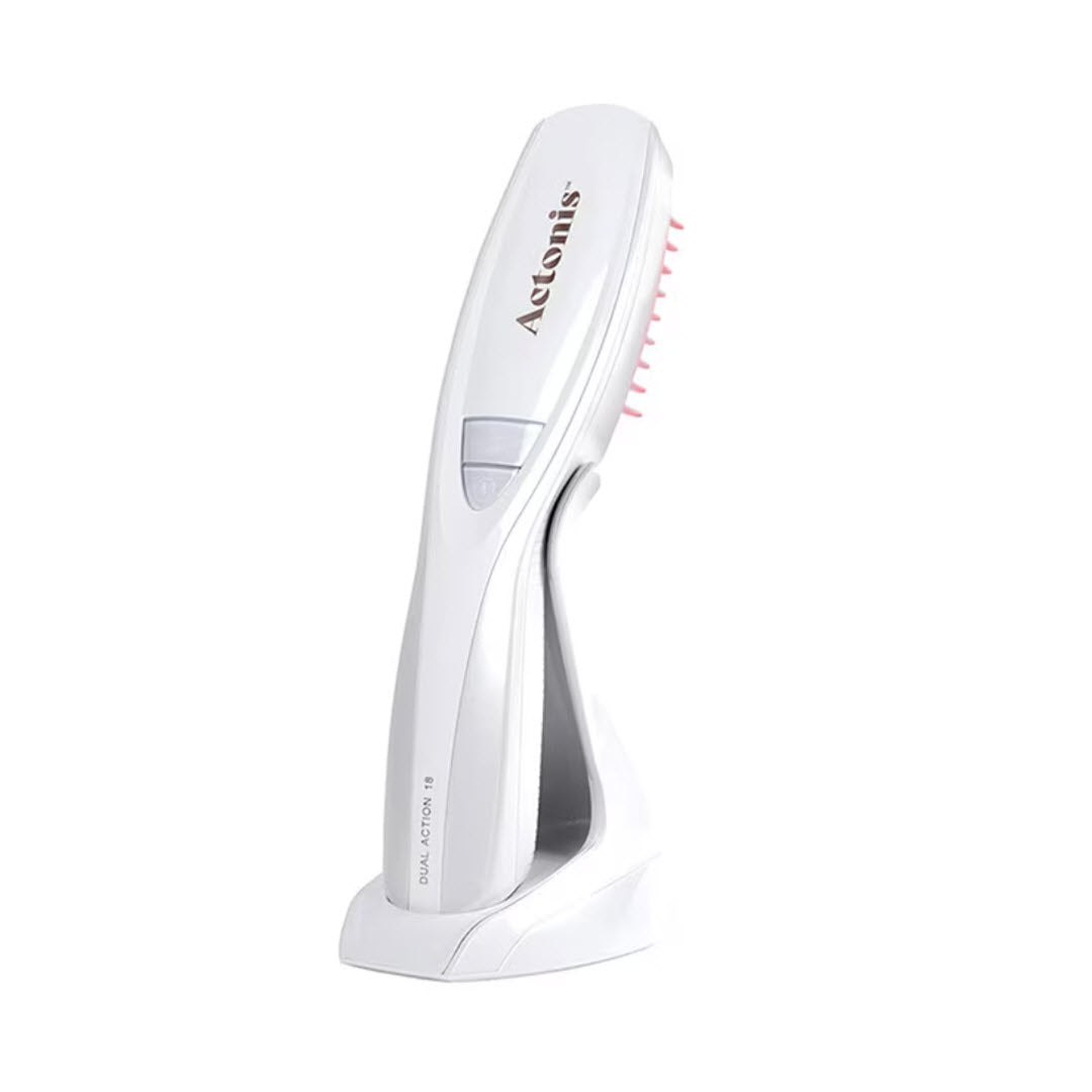 HairMax Actonis 18 Dual Action LaserComb white laser comb device on charging stand