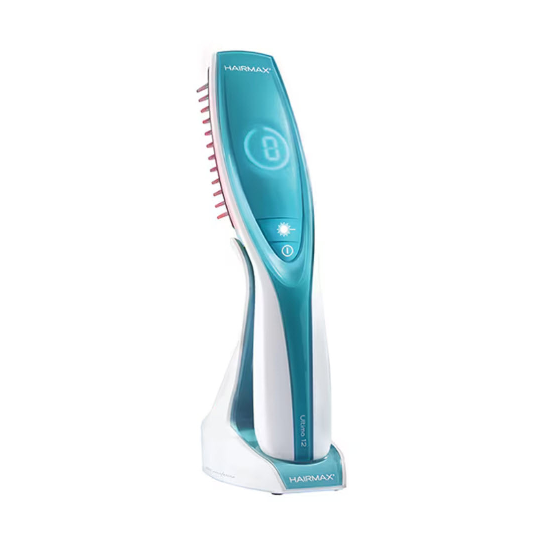 HairMax Ultima 12 LaserComb Hair Growth Device teal and white laser comb with digital treatment counter on stand