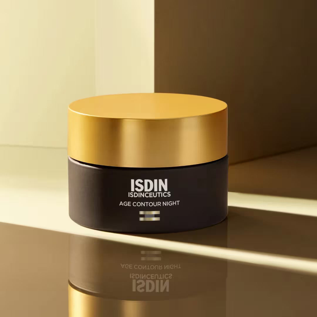 ISDIN Age Contour Night jar on reflective gold surface in warm toned setting