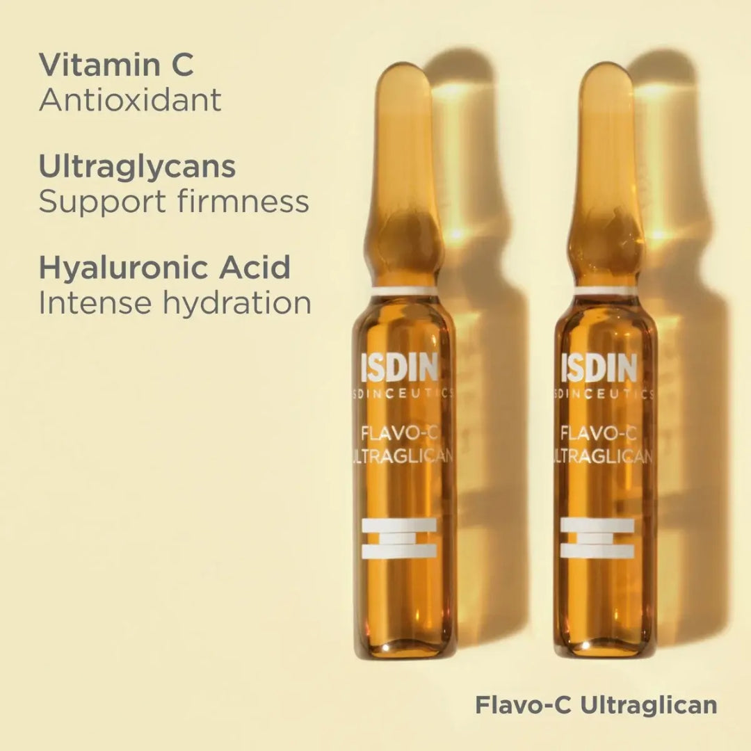 Two ISDIN Flavo-C Ultraglican ampoules lying flat on yellow background with text vitamin C antioxidant ultraglycans support firmness hyaluronic acid intense hydration