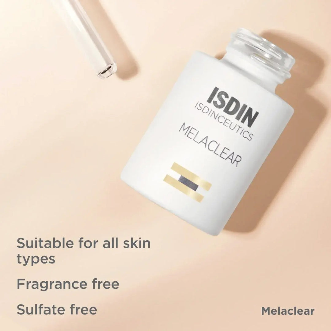 ISDIN Melaclear Serum bottle on its side beside dropper on peach background with text suitable for all skin types fragrance free sulfate free