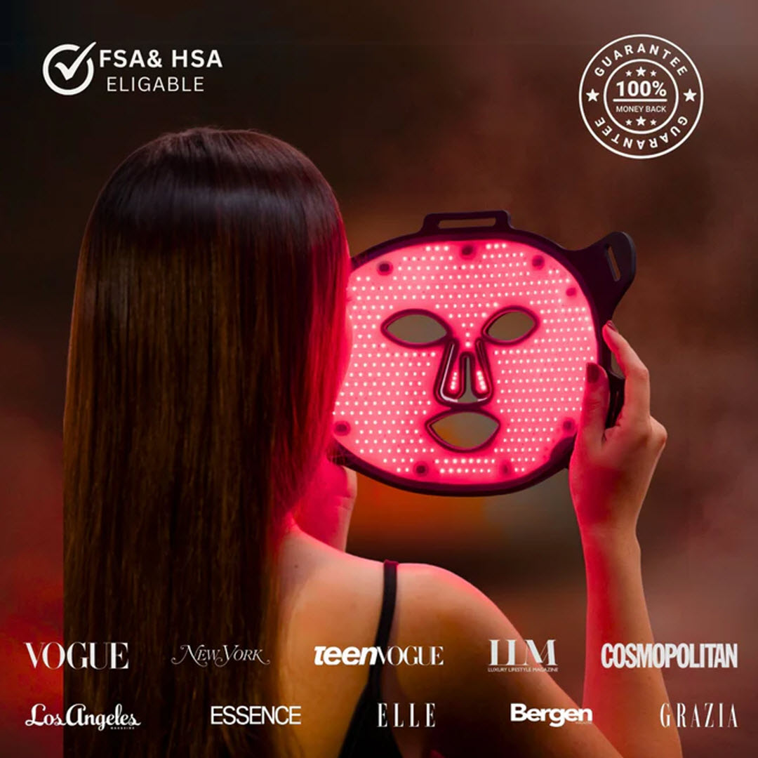 Woman holding the illuminated Lumara VISO Red Light Therapy Mask up to her face, FSA/HSA eligible with 100% money-back guarantee