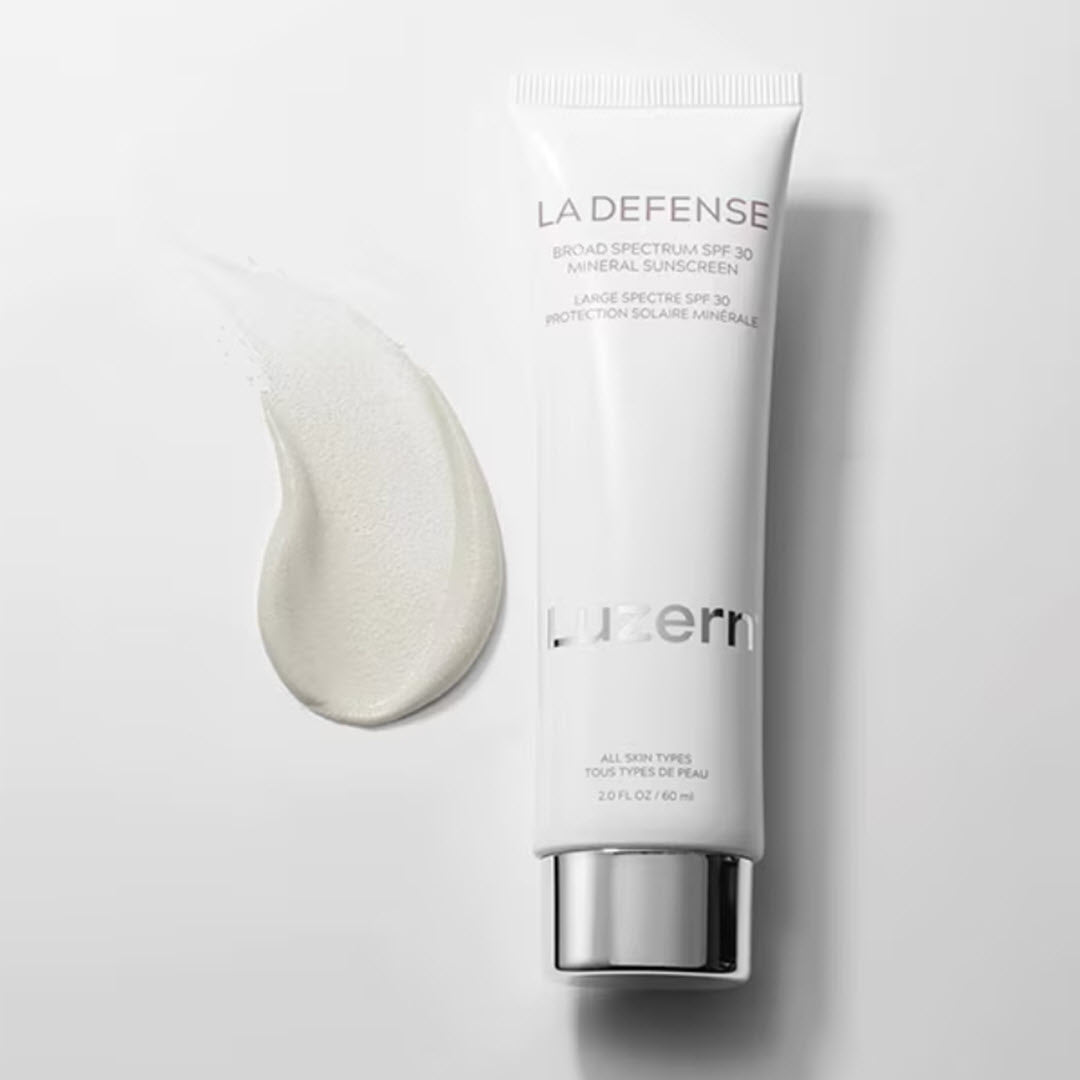 Luzern La Defense Mineral Sunscreen tube with lightweight, sheer white cream texture swatch