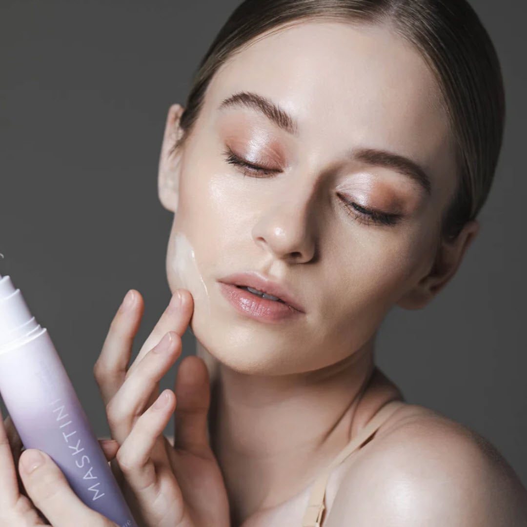 Woman applying Masktini Night Ranger Overnight Renewal Mask to her cheek