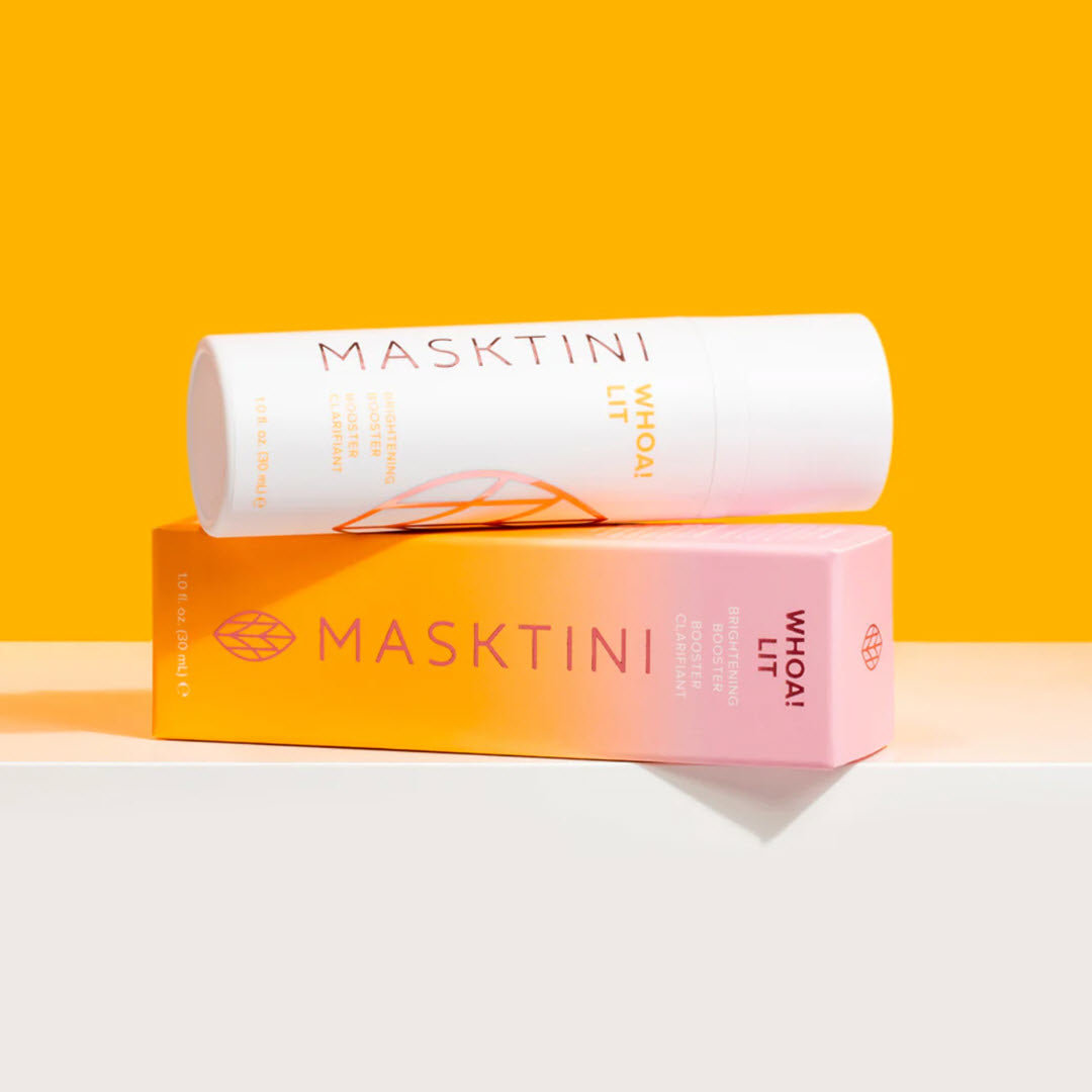 Masktini Whoa! Lit Brightening Booster bottle leaning against its retail packaging box on an orange background