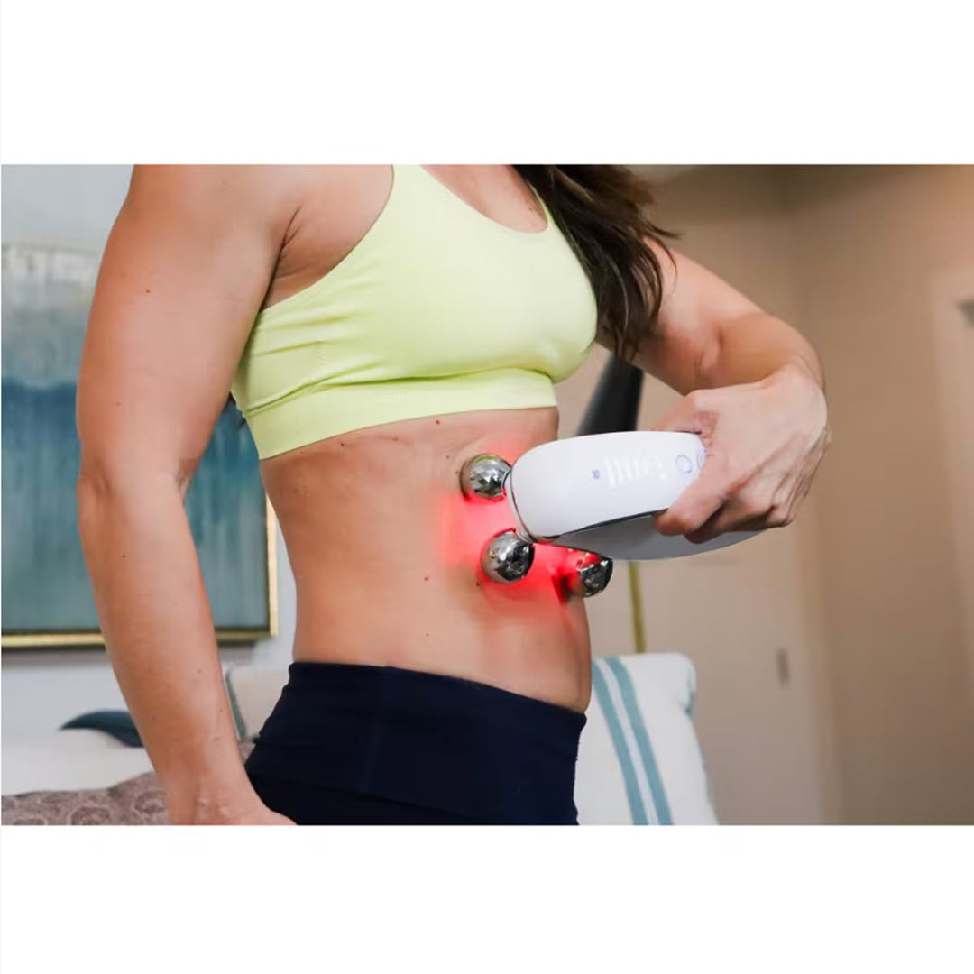 Woman using the Numiere Fat Iron Pro with red LED light therapy on her abdomen