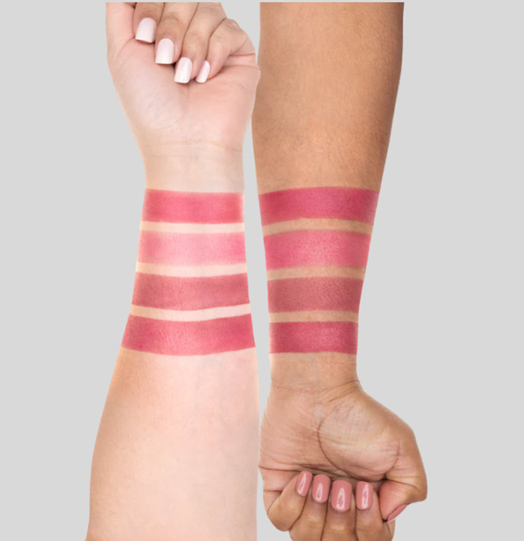 Swatches of the three OFRA Cosmetics Midi Palette Velvet Hues berry-toned shades on two skin tones