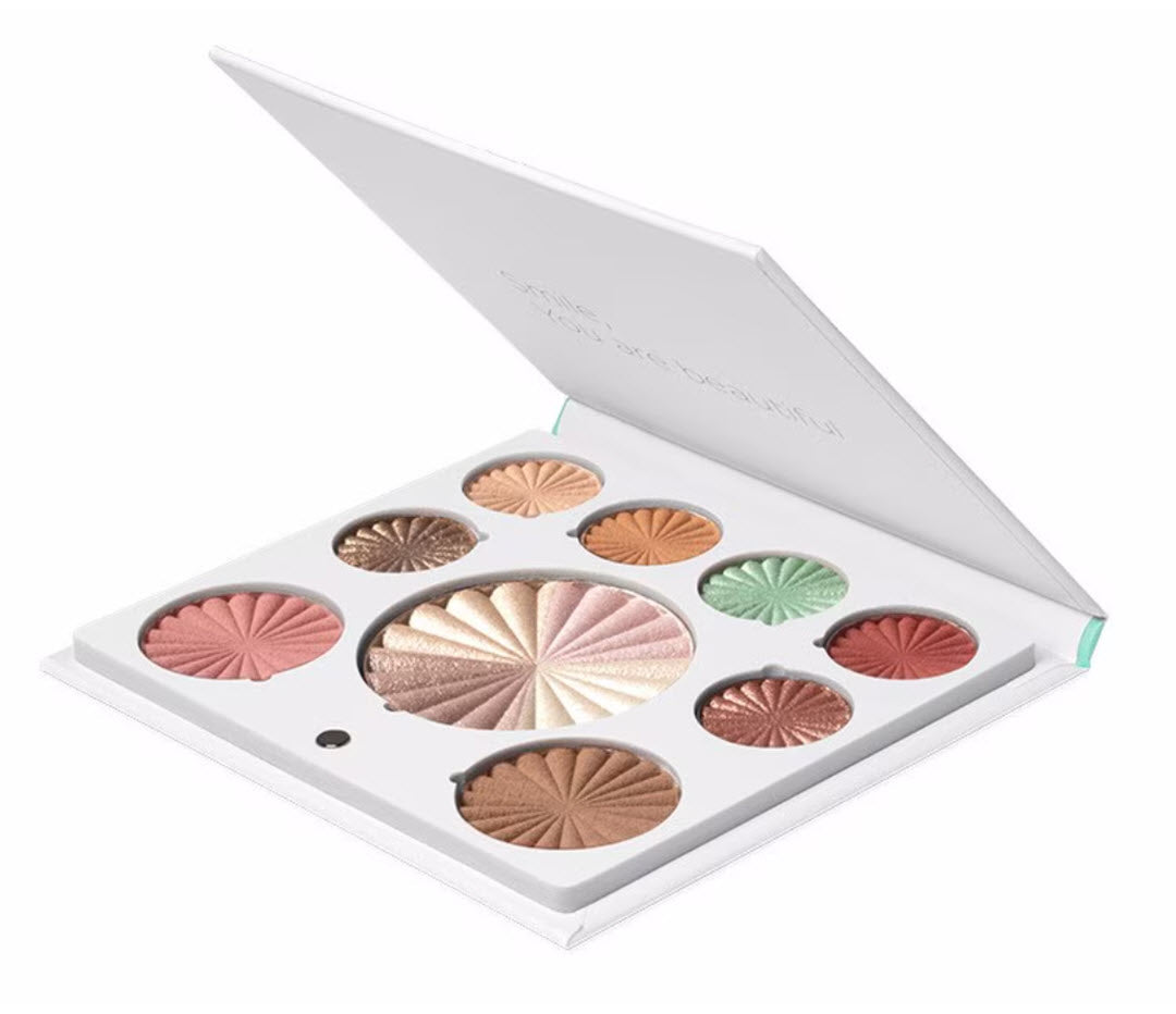 Angled view of OFRA Cosmetics Mini Mix Face Palette Good to Go open compact with Smile You're Beautiful lid message