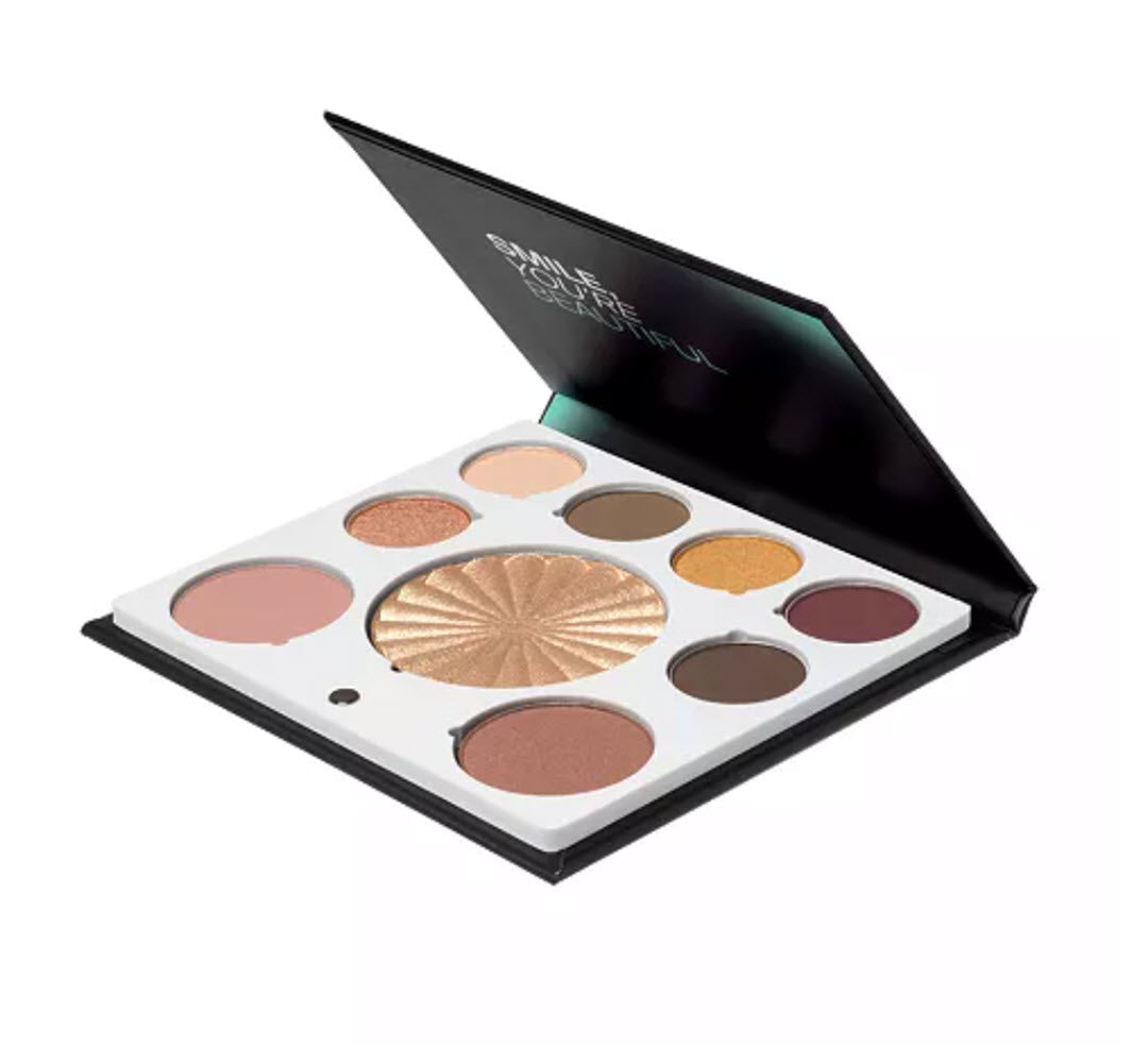 Angled view of OFRA Cosmetics Mini Mix Face Palette New Solstice open compact with Smile You're Beautiful lid message