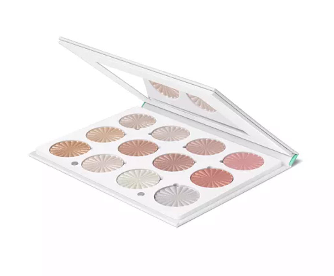 Angled view of OFRA Cosmetics Pro Palette Next Level Glow open compact with built-in mirror showing all 12 highlighter shades