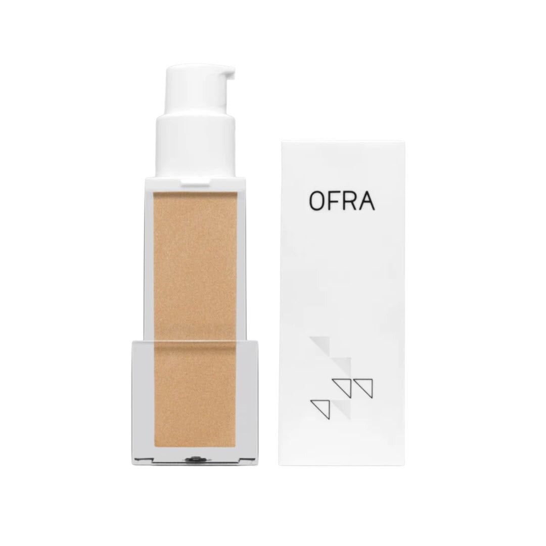 OFRA Cosmetics Rodeo Drive Primer pump bottle shown next to its retail box, a golden champagne illuminating primer