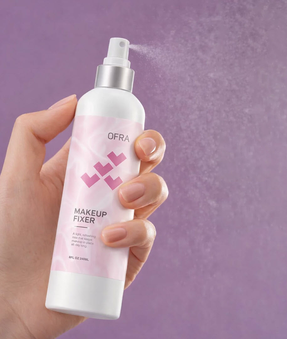 Hand holding and spraying OFRA Cosmetics Rose Makeup Fixer setting spray