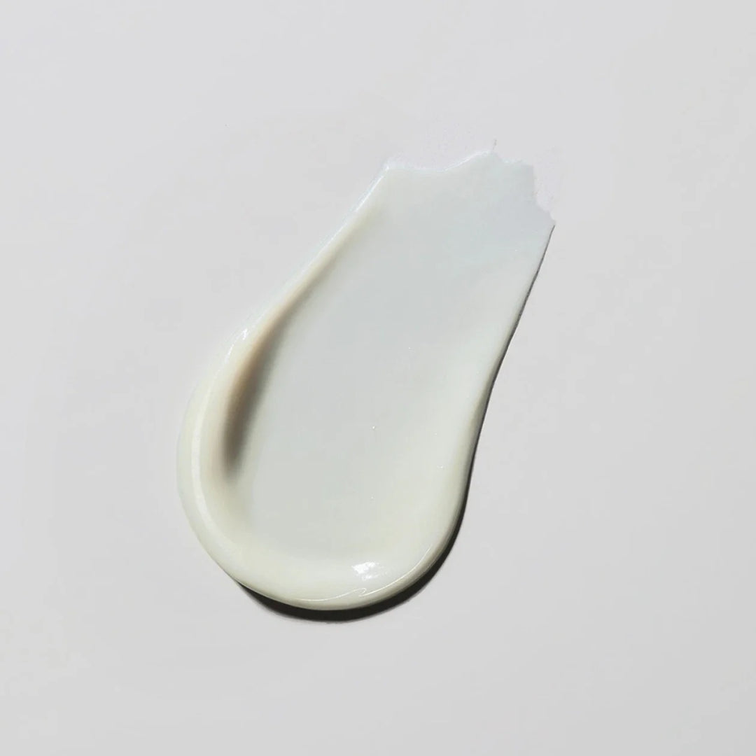 Obagi Retinol 1.0 cream texture swatch on gray background