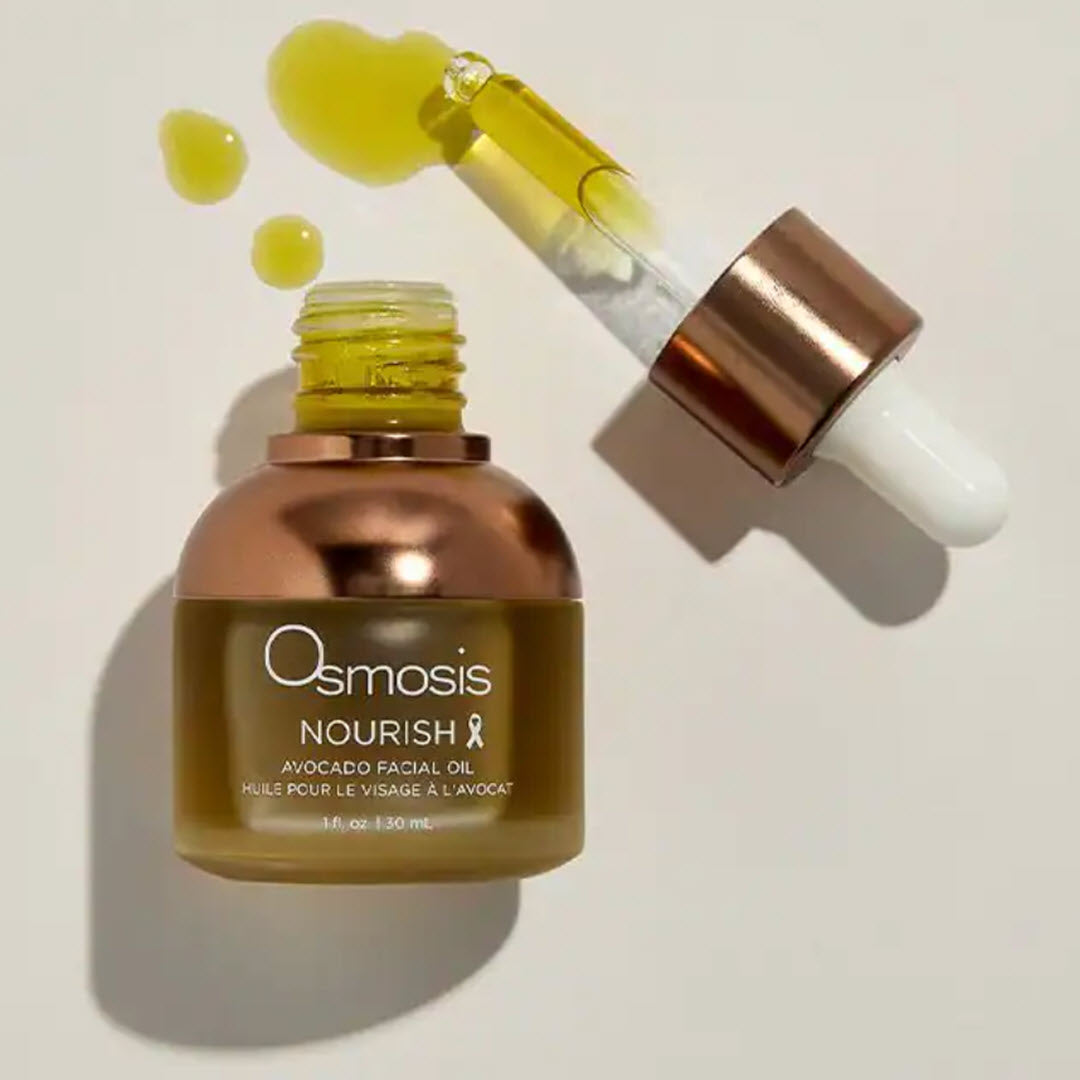 Osmosis Nourish Avocado Facial Oil open bottle with dropper and a few drops of golden oil