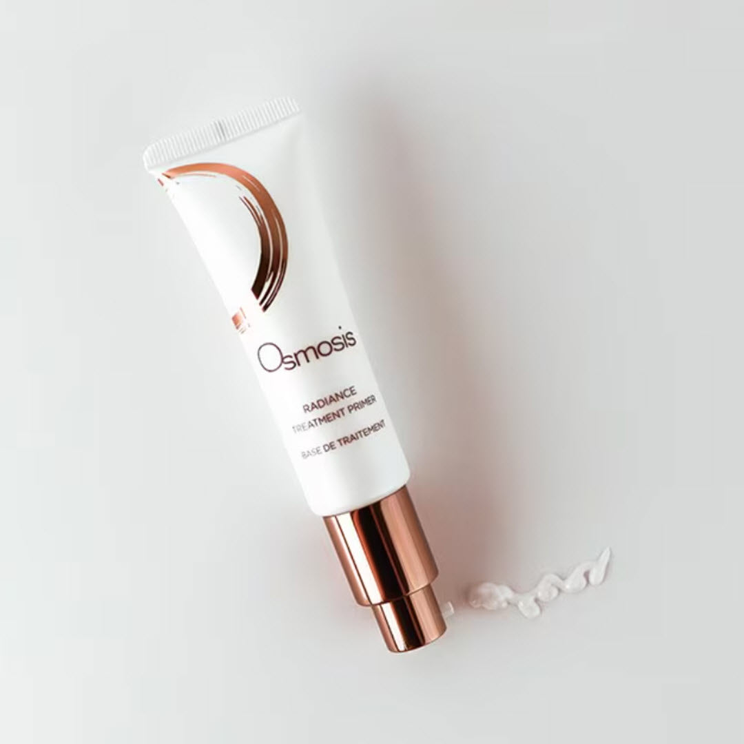 Osmosis Radiance Treatment Primer tube tilted with a swipe of the lightweight glow-boosting formula