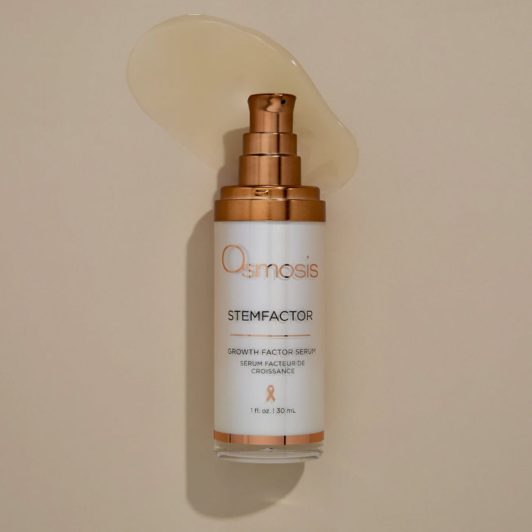 Osmosis StemFactor Growth Factor Serum bottle with a swipe of the lightweight, silky serum
