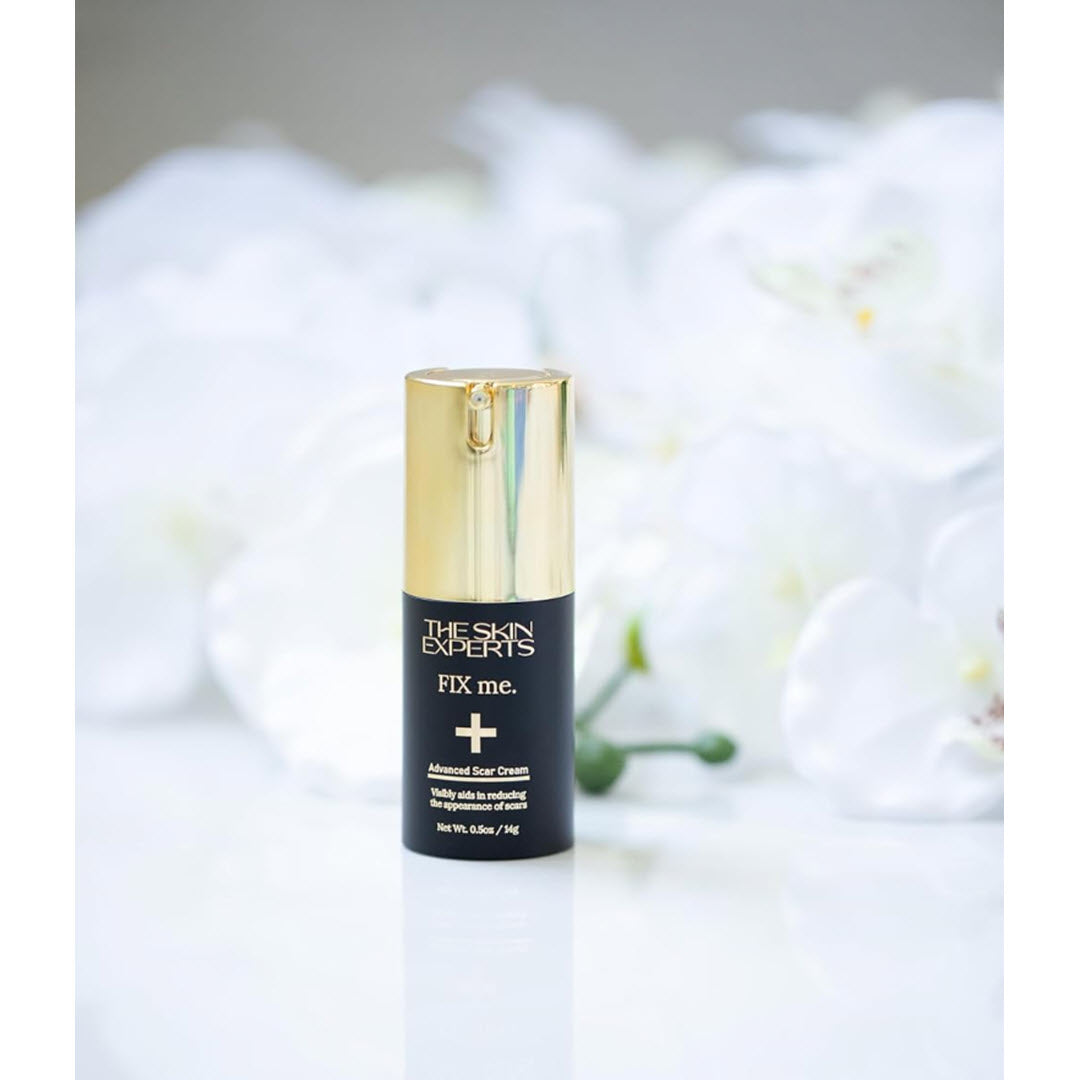 The Skin Experts FIX me. Advanced Scar Cream bottle styled with white orchids