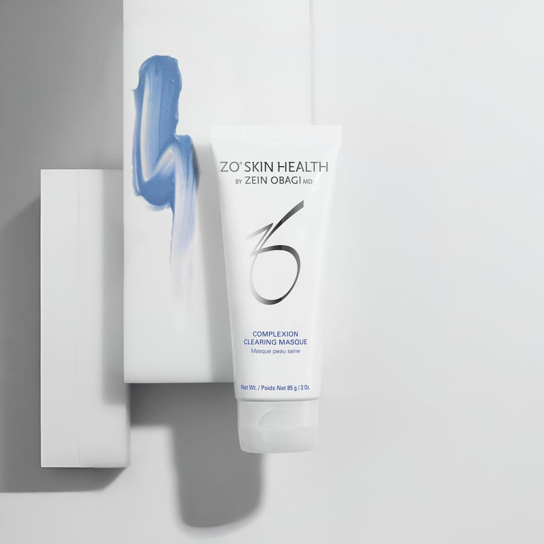 ZO Skin Health Complexion Clearing Masque tube with blue masque texture swatch on geometric white display – deep-cleansing treatment for a clearer complexion