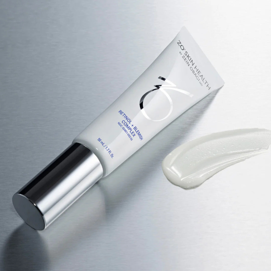 ZO Skin Health Retinol + Blemish Complex white tube on metallic surface with cream swatch – dual-action retinol and acne-clearing formula for clearer skin