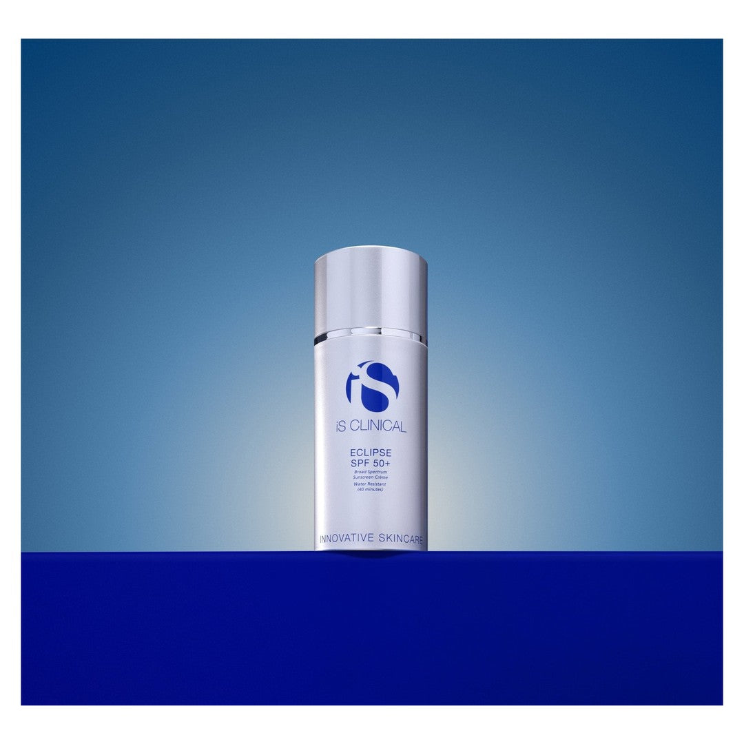 iS Clinical Eclipse SPF 50+ PerfecTint Beige bottle on a blue gradient background