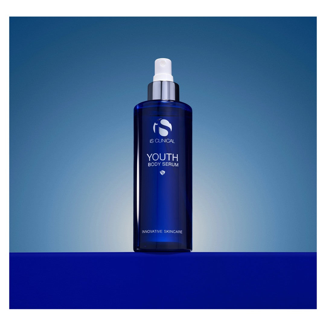 iS Clinical Youth Body Serum bottle on a blue gradient background